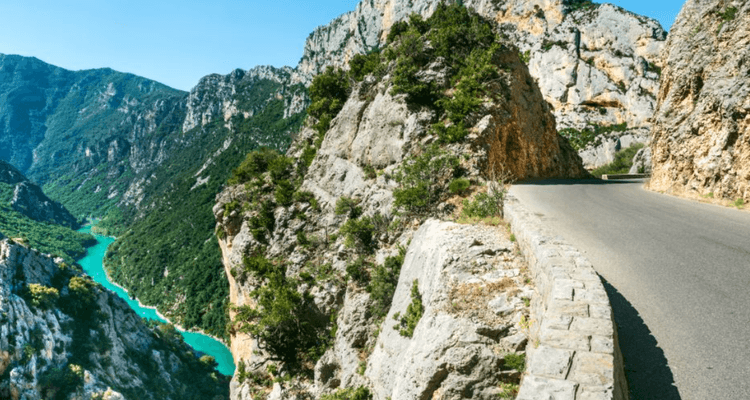 A clif by a green river