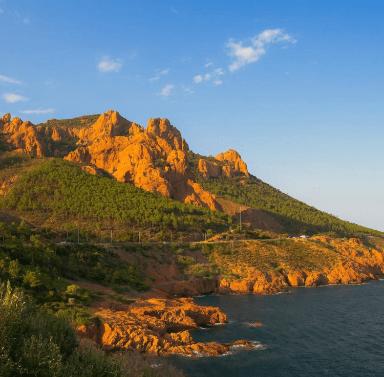 A red mountain by the sea
